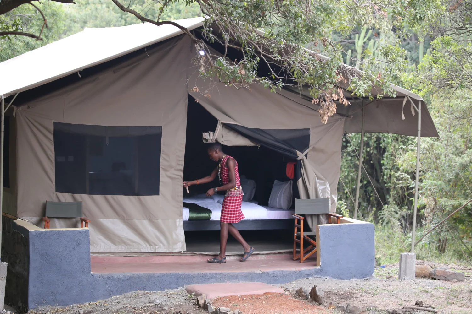 IMG_0336 a man in a plaid dress standing in a tent- 4- day masai mara
